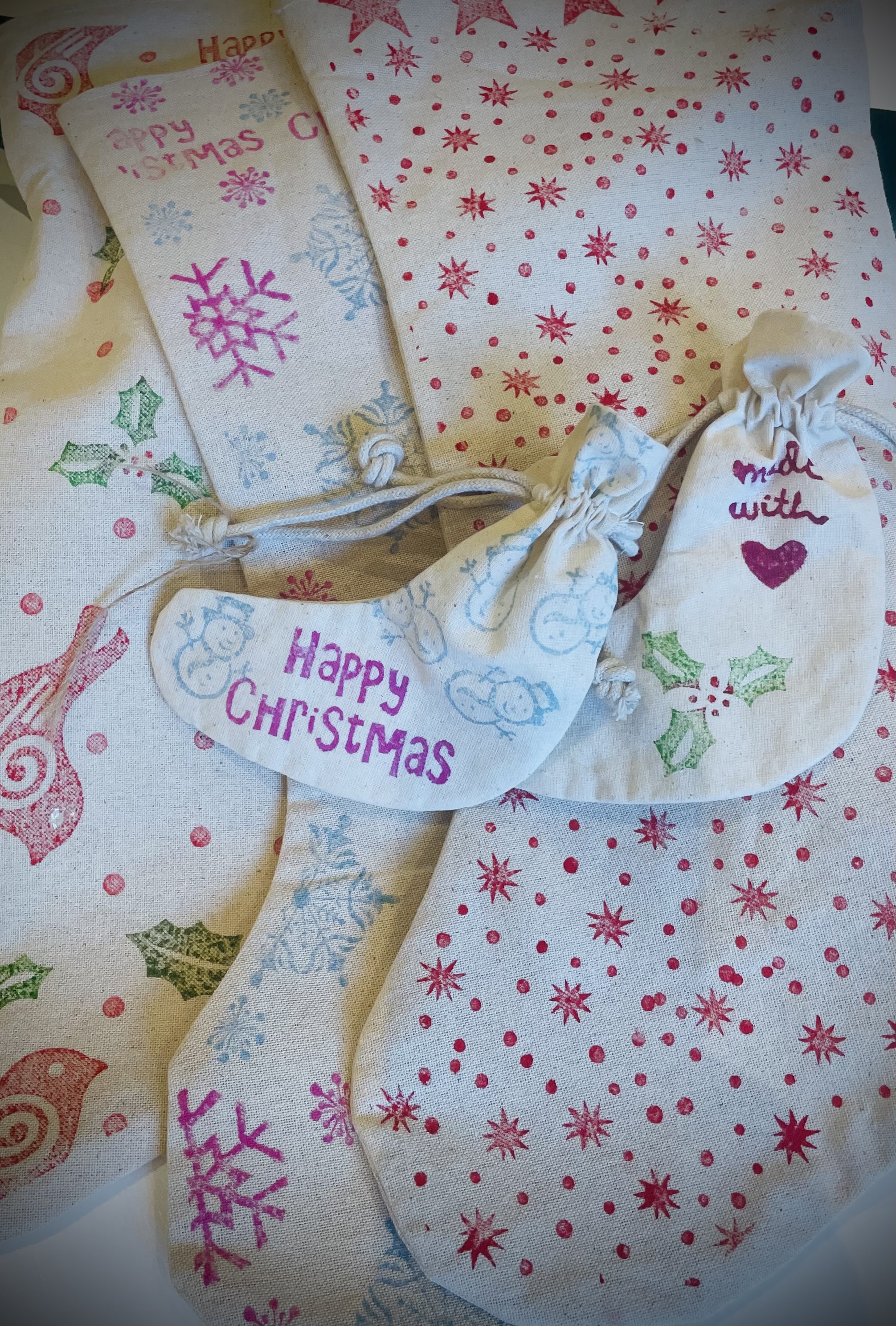 Mini Christmas stockings with different prints, including red starts, pink snowflakes, green holly and red robins.