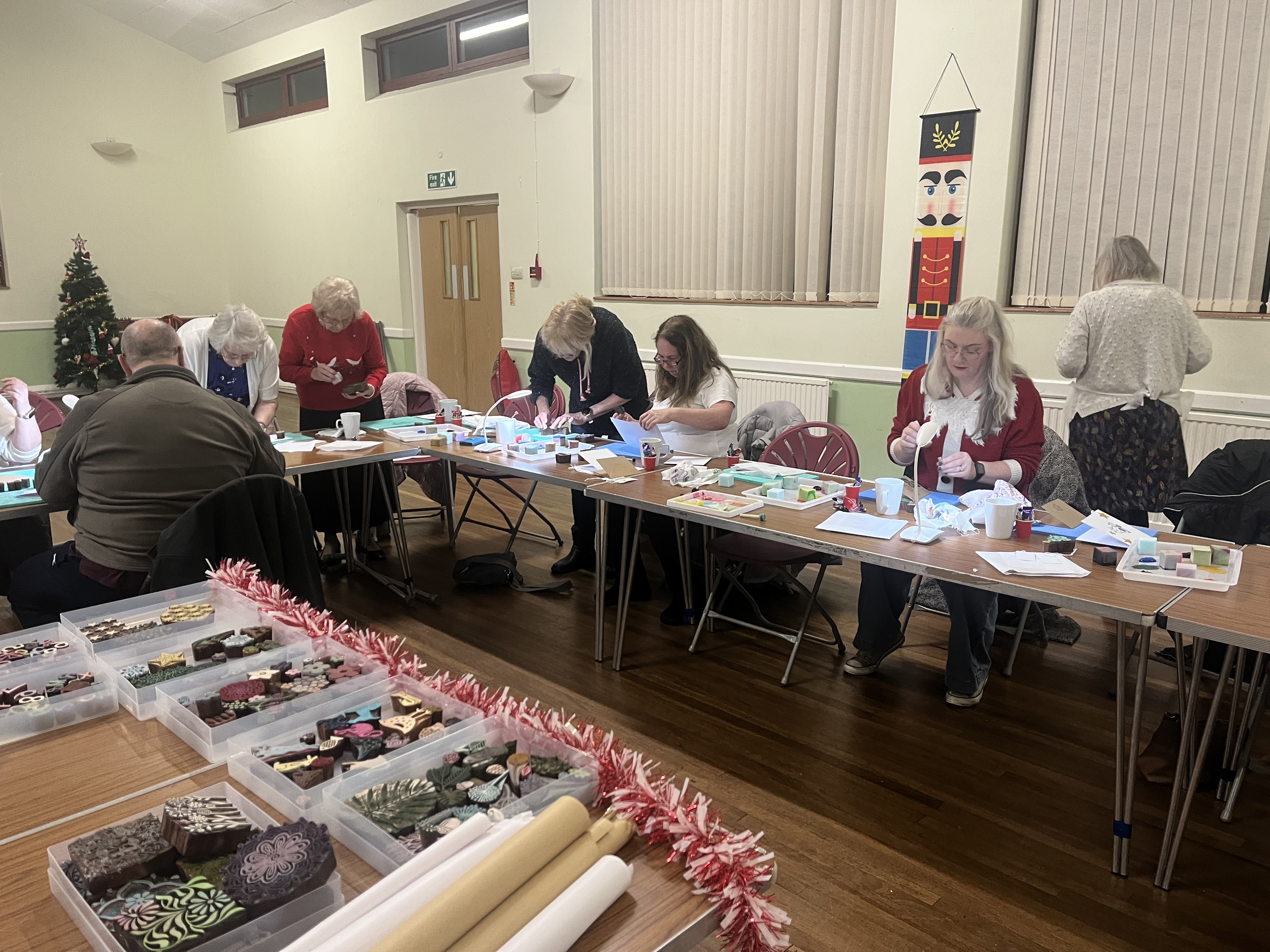 a group of adults enjoying a block printing workshop.