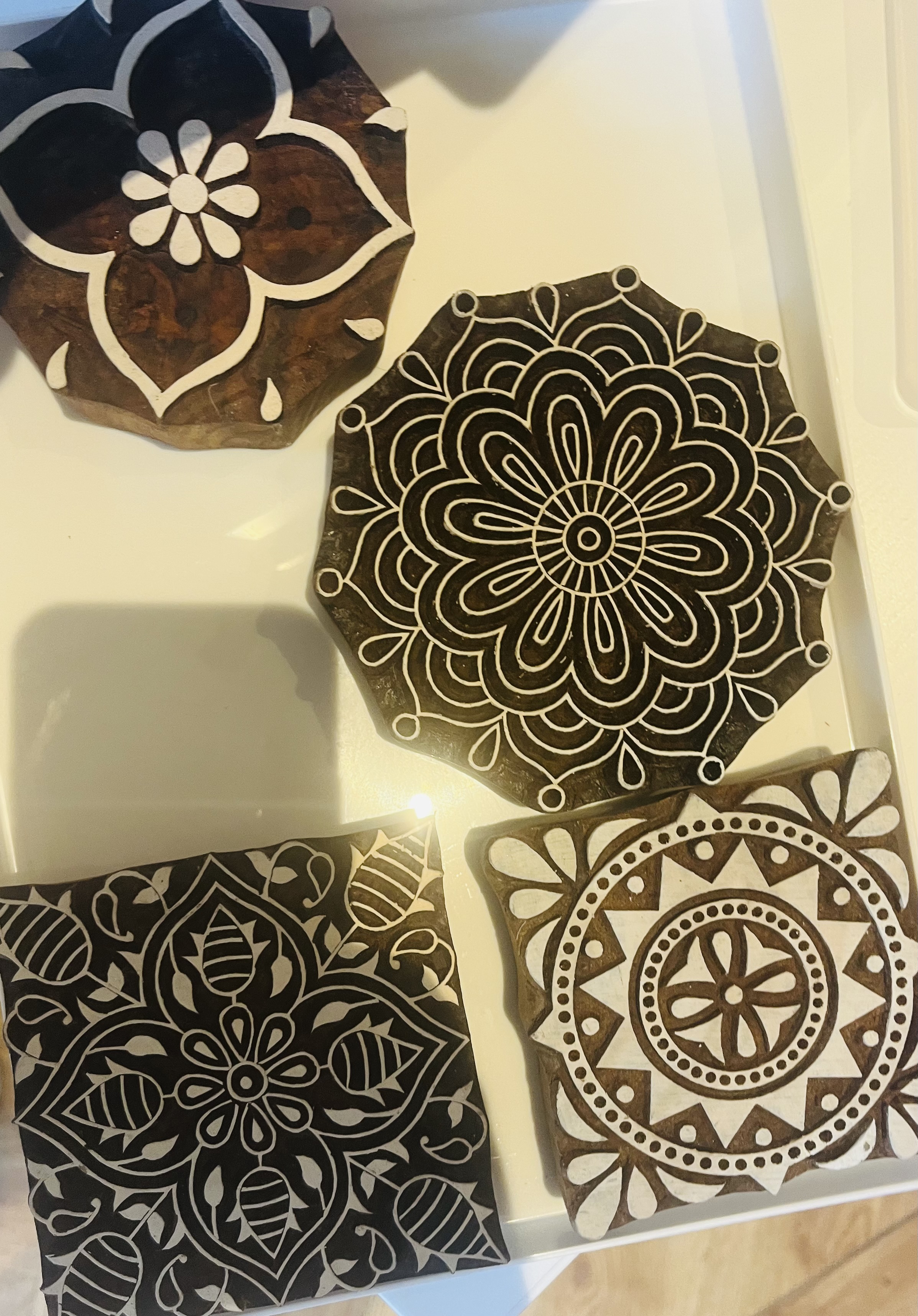 large wooden Indian blocks with patterns of flowers, circles and lines.