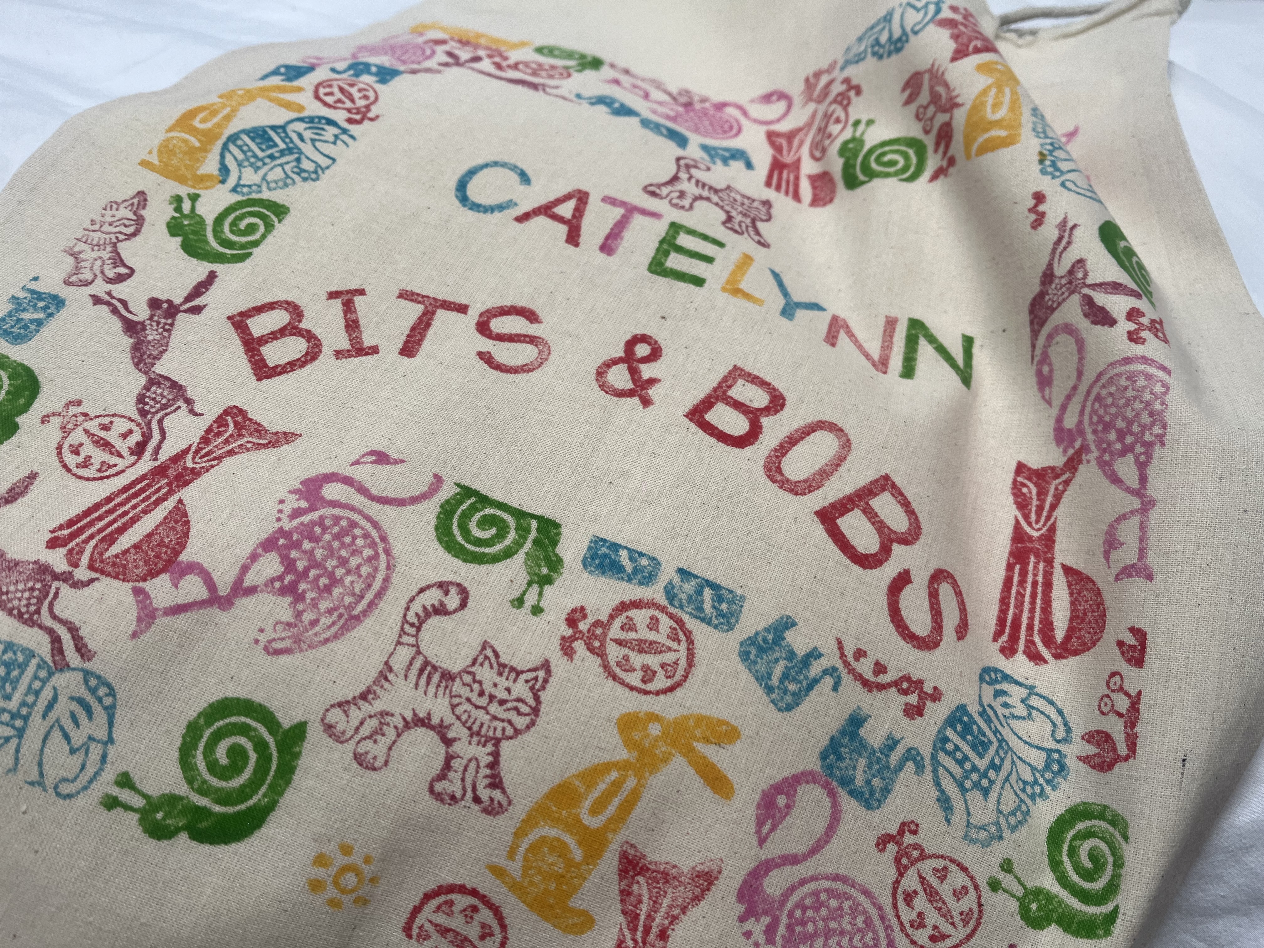 A bag decorated with colourful animals and text